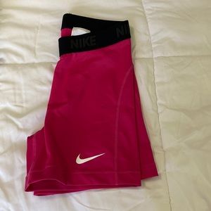 Women’s pink Nike Dri-fit training shorts.